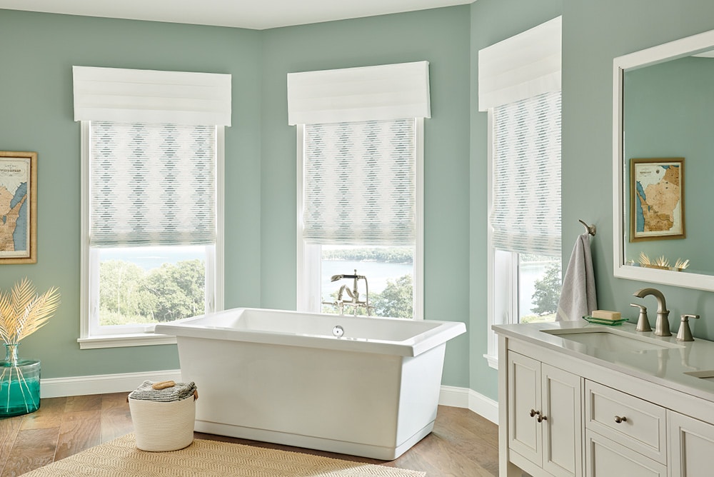 Roman Shades filtering in light into a bathroom