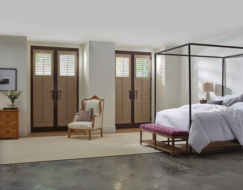 Wood shutter doors, filtering in light into a beautiful master bedroom.